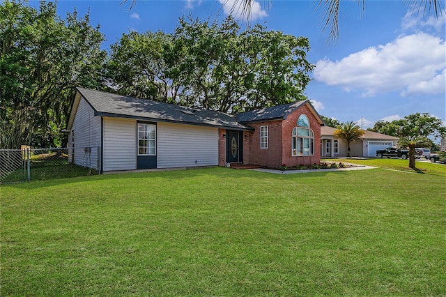 view of front of property featuring a front yard and a garage