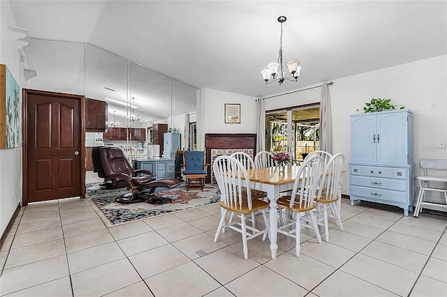 tiled dining room featuring lofted ceiling, a textured ceiling, and a notable chandelier