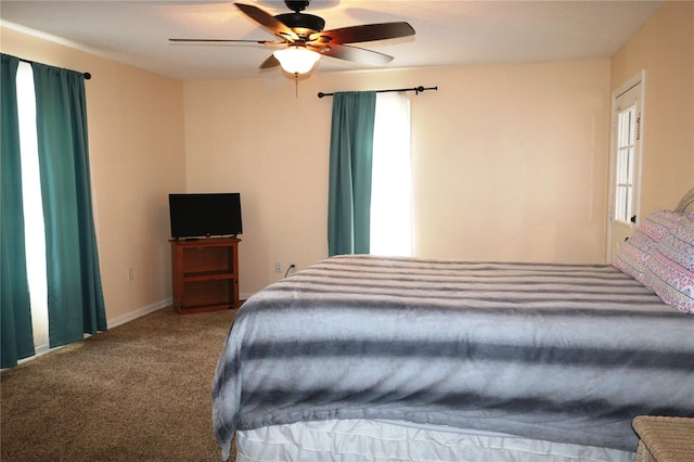 carpeted bedroom featuring multiple windows and ceiling fan