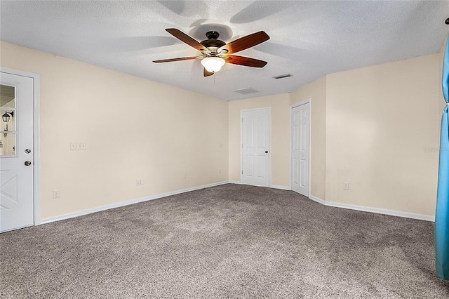 carpeted spare room with a textured ceiling and ceiling fan