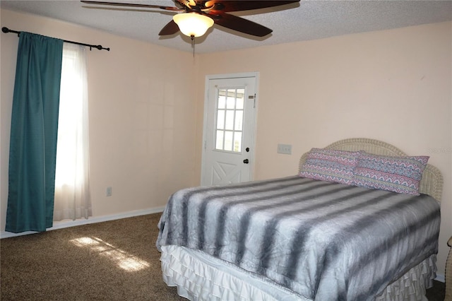 bedroom featuring a textured ceiling, carpet, and ceiling fan