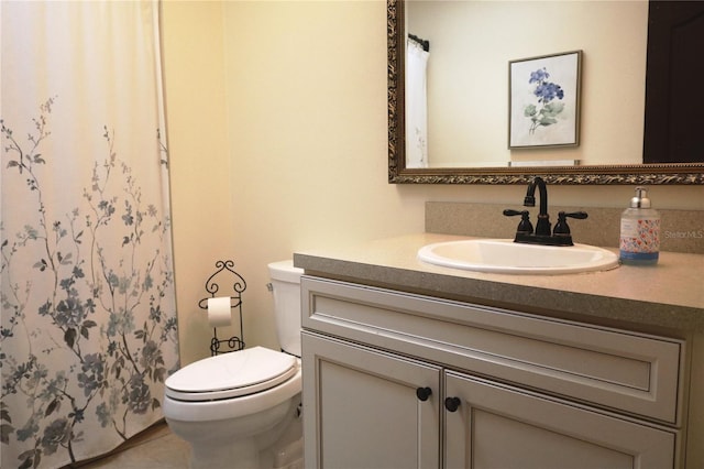 bathroom with vanity, toilet, and tile patterned flooring