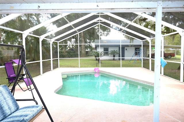 view of swimming pool with a yard, a patio area, and glass enclosure