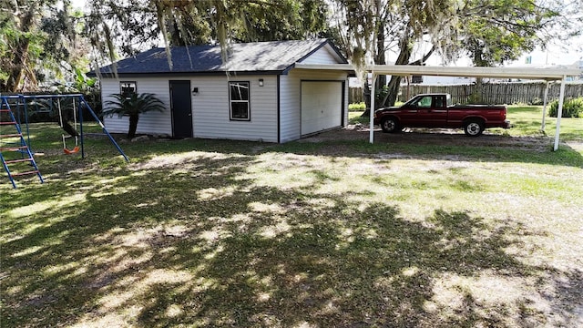 exterior space with a playground, an outbuilding, and a carport