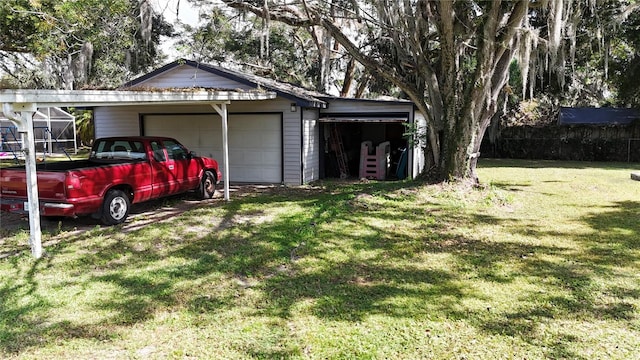 exterior space with a garage, a lawn, and a carport