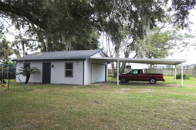 view of front of property featuring a front yard and a carport