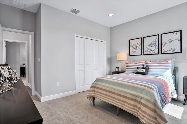 bedroom featuring light colored carpet and a closet