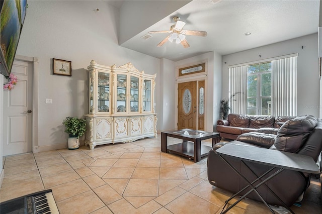 living room with ceiling fan and light tile patterned floors