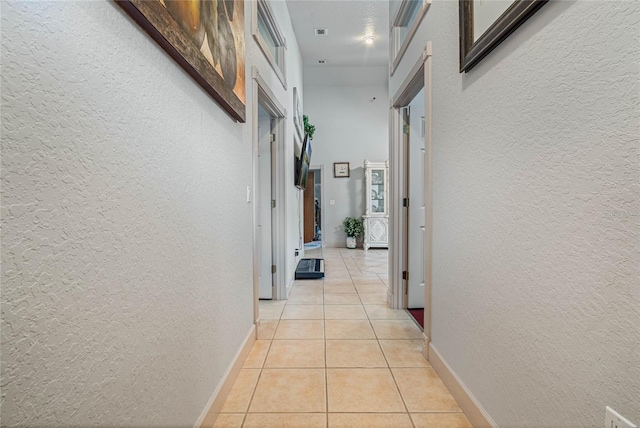 corridor with light tile patterned floors