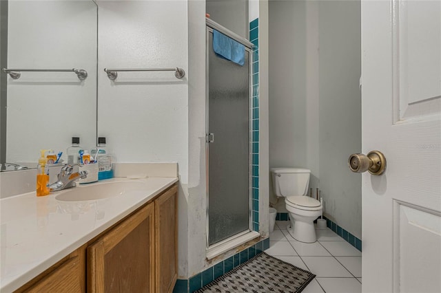 bathroom with vanity, tile patterned floors, toilet, and walk in shower