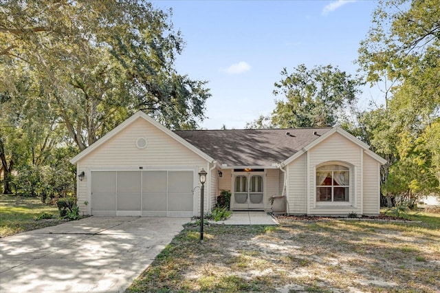 ranch-style house with a front yard and a garage