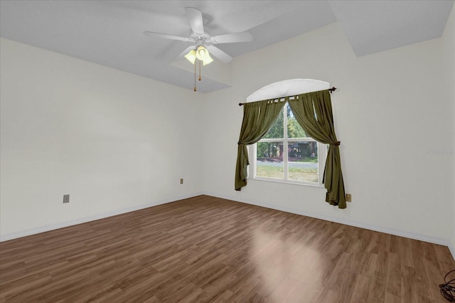 unfurnished room featuring ceiling fan and dark hardwood / wood-style flooring