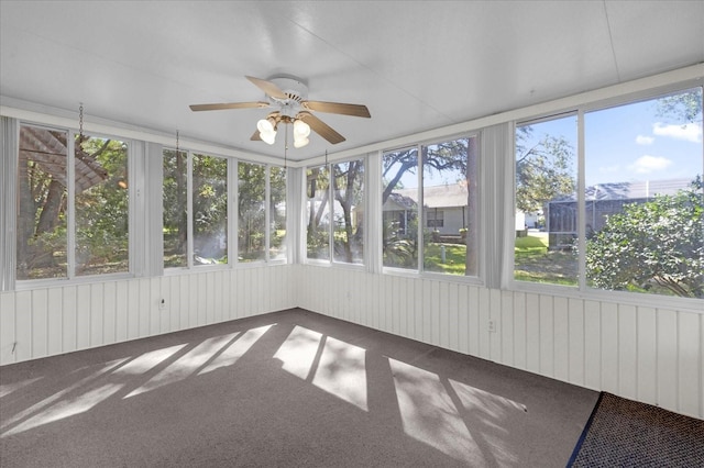 unfurnished sunroom featuring a healthy amount of sunlight and ceiling fan