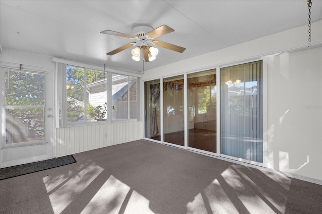 unfurnished sunroom featuring ceiling fan