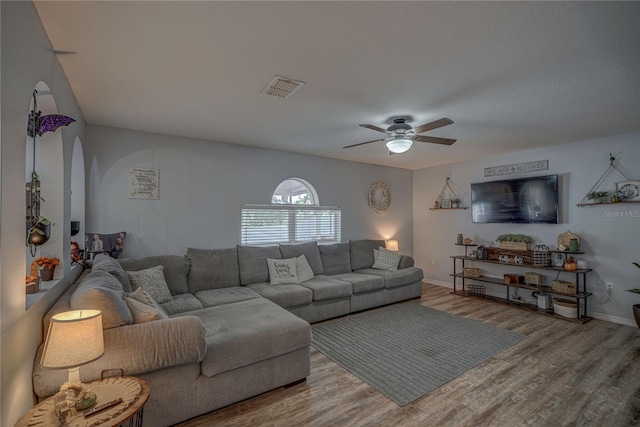 living room with wood-type flooring and ceiling fan