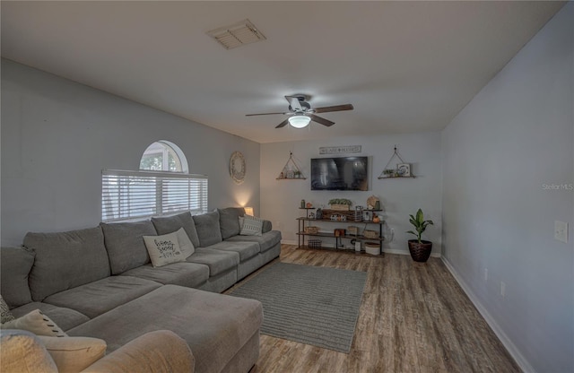 living room with hardwood / wood-style floors and ceiling fan