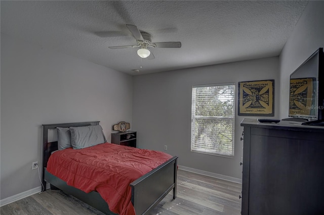 bedroom featuring a textured ceiling, hardwood / wood-style floors, and ceiling fan