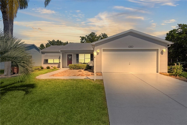 ranch-style home with a garage, concrete driveway, and a lawn