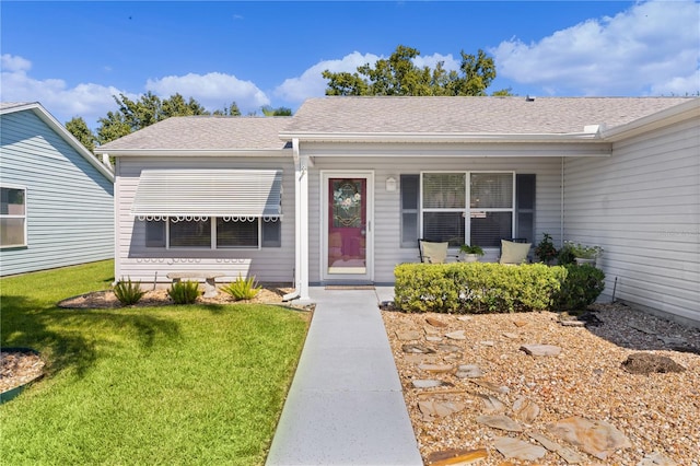 property entrance with a lawn