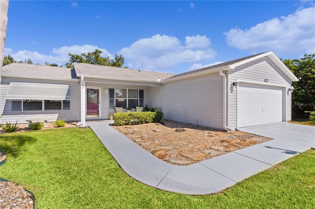 single story home featuring a garage, driveway, and a front lawn