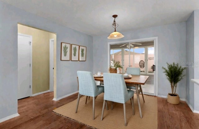 dining area featuring wood finished floors and baseboards