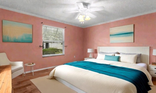 bedroom featuring a textured ceiling, ceiling fan, baseboards, light wood finished floors, and crown molding