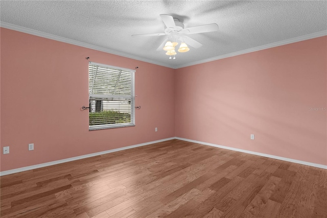 spare room with ceiling fan, ornamental molding, and wood finished floors