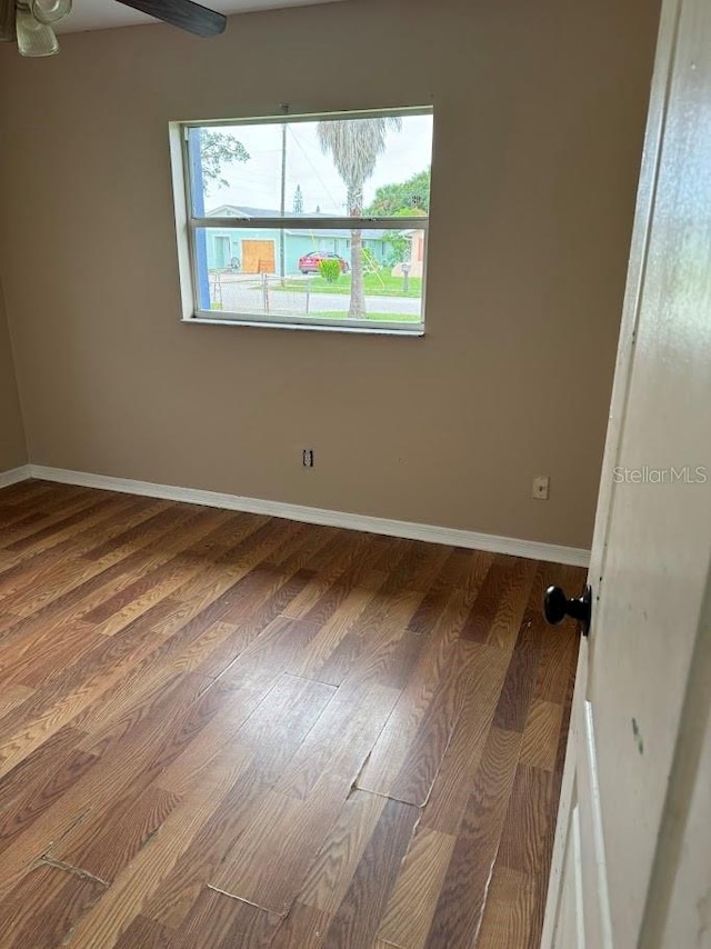 spare room with hardwood / wood-style floors