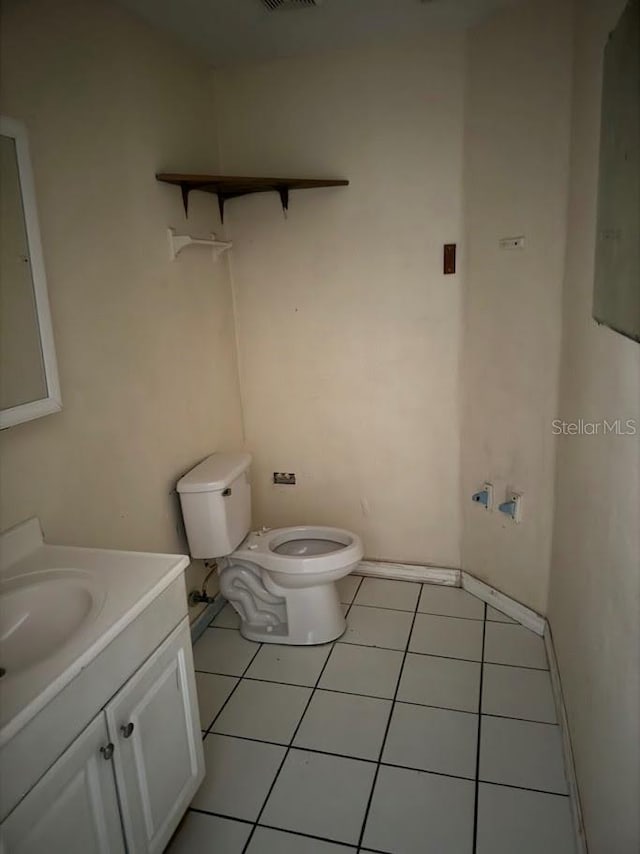 bathroom with tile patterned floors, vanity, and toilet