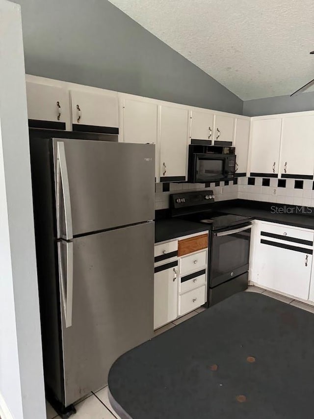 kitchen featuring black appliances, vaulted ceiling, a textured ceiling, tasteful backsplash, and white cabinetry