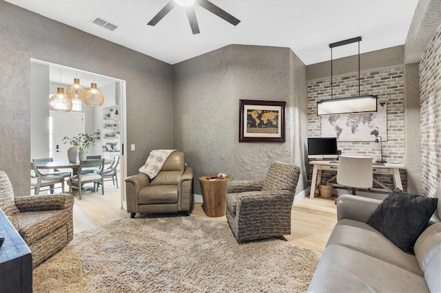 living room featuring wood-type flooring and ceiling fan