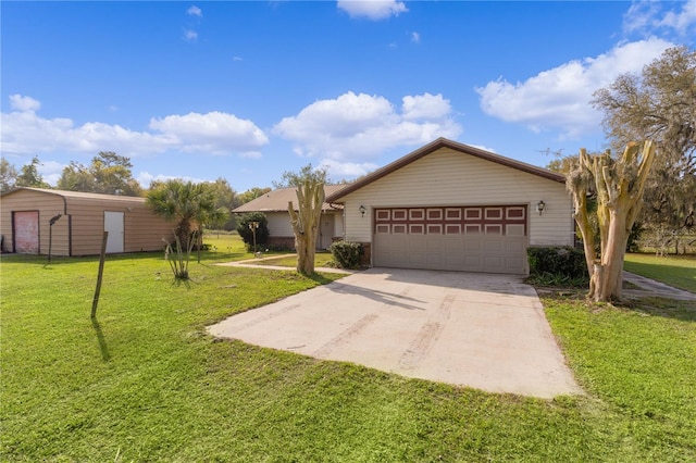 single story home featuring an outbuilding, a front lawn, and a garage