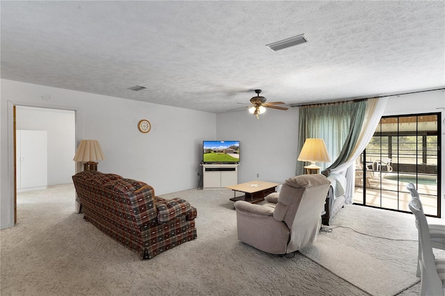 living room with light carpet, a textured ceiling, and ceiling fan