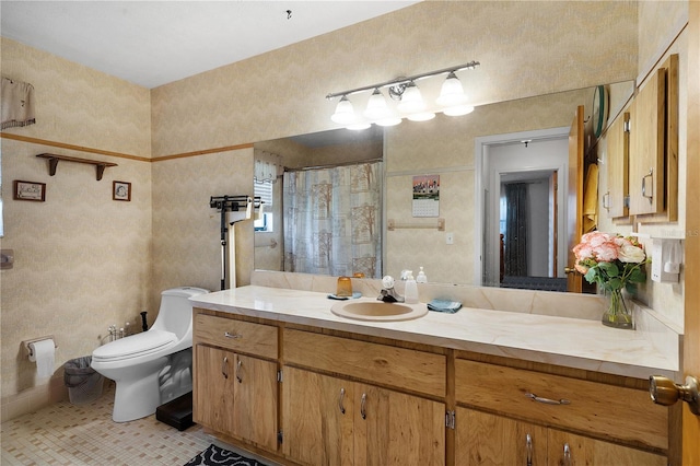 bathroom featuring walk in shower, vanity, toilet, and tile patterned flooring