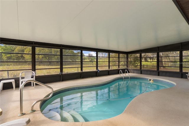 view of swimming pool with a patio and glass enclosure