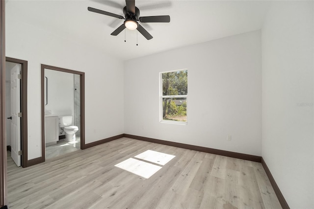 unfurnished bedroom with ensuite bath, light wood-type flooring, and ceiling fan