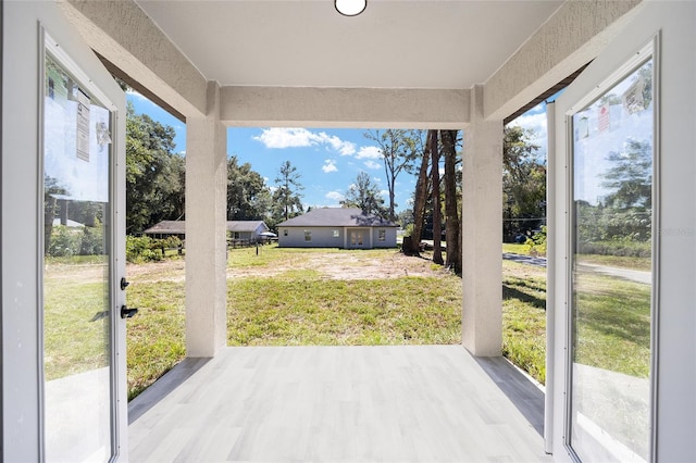 unfurnished sunroom featuring a healthy amount of sunlight