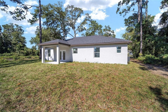 back of property featuring a lawn