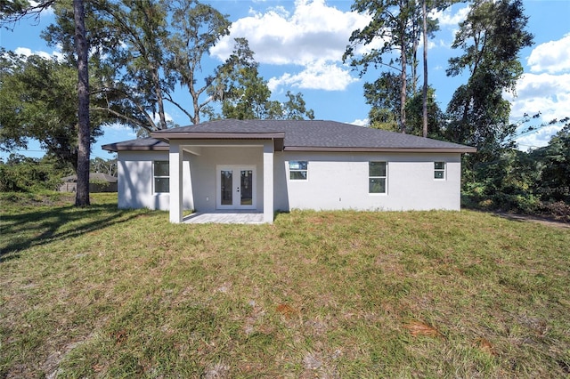 rear view of property with a yard