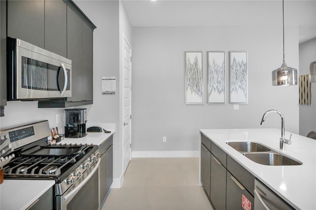 kitchen featuring sink, appliances with stainless steel finishes, and hanging light fixtures