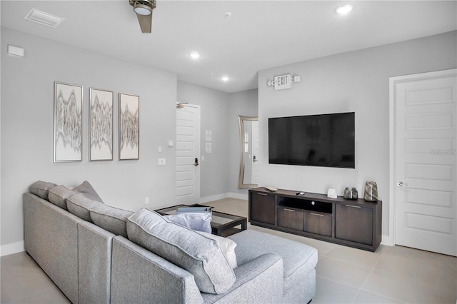 living room featuring light tile patterned floors and ceiling fan