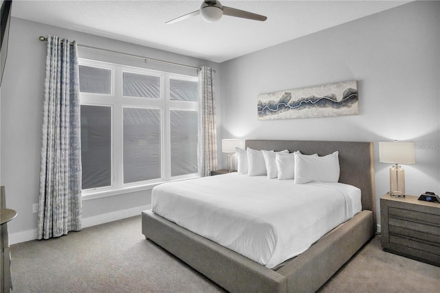 bedroom featuring ceiling fan and light colored carpet