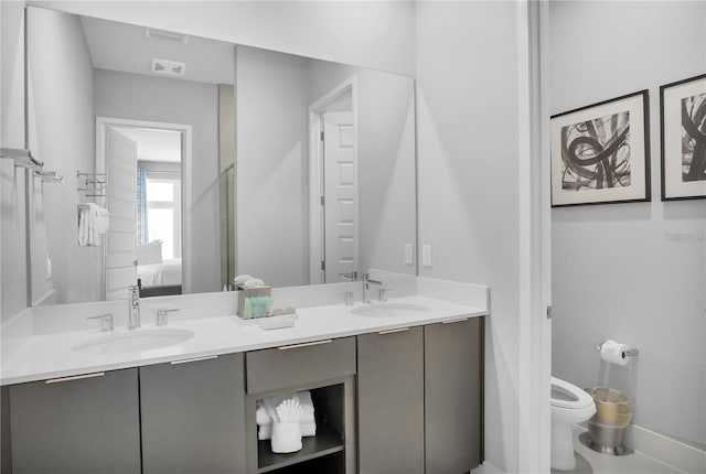 bathroom featuring vanity and toilet