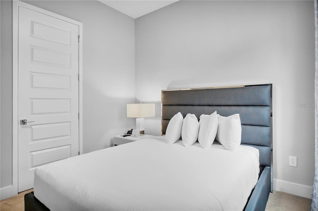 bedroom featuring light colored carpet