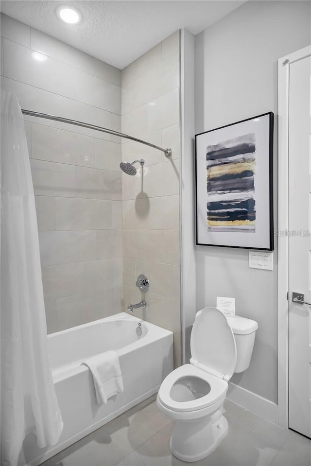 bathroom with toilet, shower / bathtub combination with curtain, a textured ceiling, and tile patterned flooring