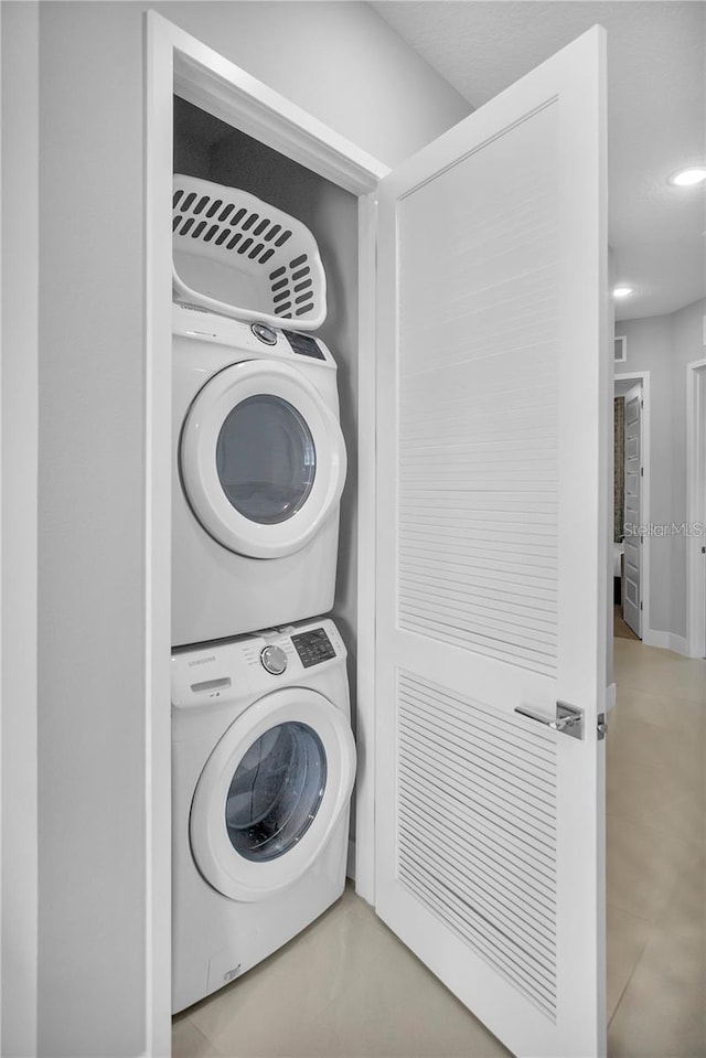 laundry room with stacked washer and dryer