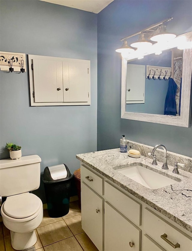 bathroom featuring vanity, tile patterned floors, and toilet