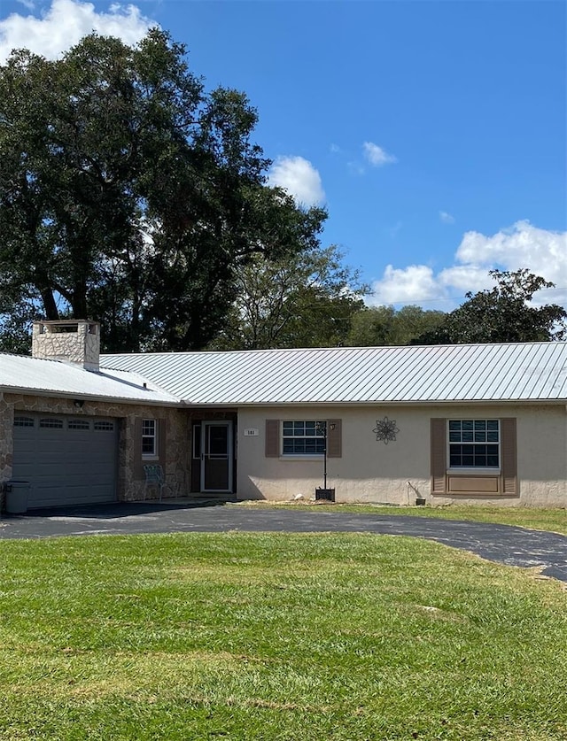 ranch-style home with a garage and a front yard