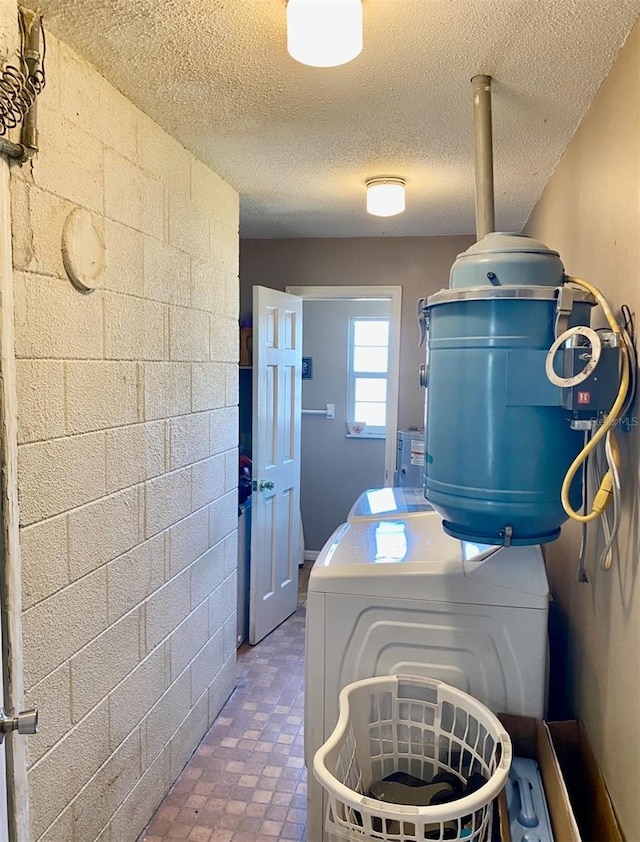 laundry room with washer / clothes dryer and a textured ceiling