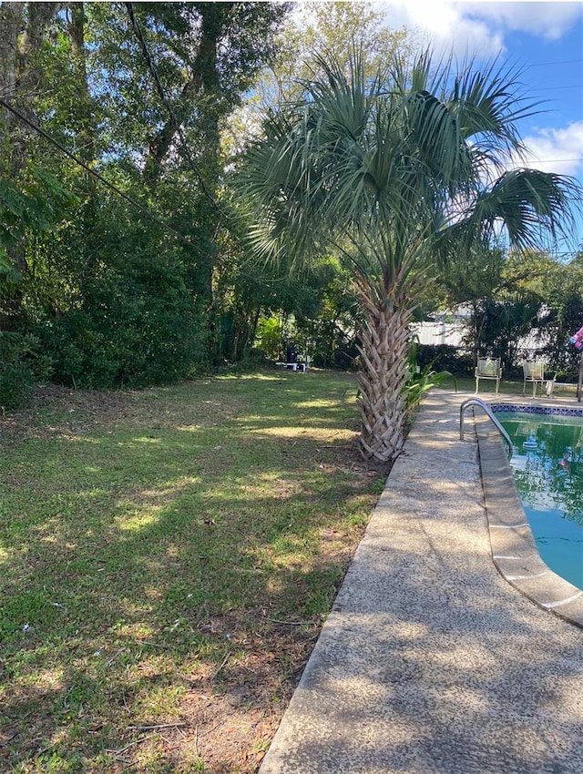 view of yard with a fenced in pool